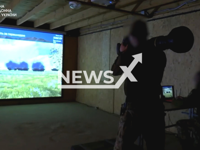 Ukrainian soldier aims NLAW in an interactive shooting range in Ukraine in undated photo. Border guards learn and train to use British and Swedish NLAW portable anti-tank guided missile system in virtual reality. Note: Picture is a screenshot from a video (@/DPSUkraine/Newsflash)