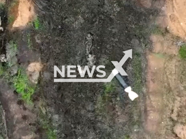 Bomb falls to dugout with Russian soldiers in a field area in Ukraine in undated photo. Fighters of the Rapid Reaction Brigade of the National Guard of Ukraine dropped bombs on Russian soldiers from UAV (unmanned aerial vehicle). Note: Picture is a screenshot from a video (@RapidReactionBrigade/Newsflash)