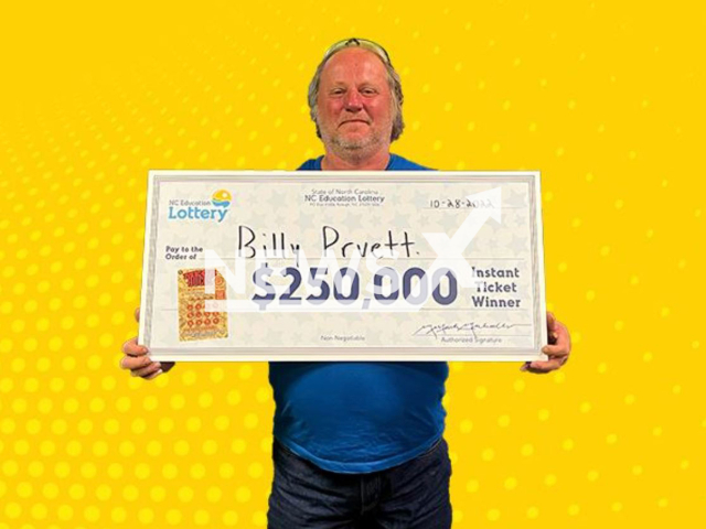 Billy Pruett  poses with a check from wining the lottery, undated. He said the scratch-off lottery ticket that earned him a USD 250,000 prize was only the second lottery ticket he had ever bought.  
Note: Licensed photo.  (North Carolina Education Lottery/Newsflash)