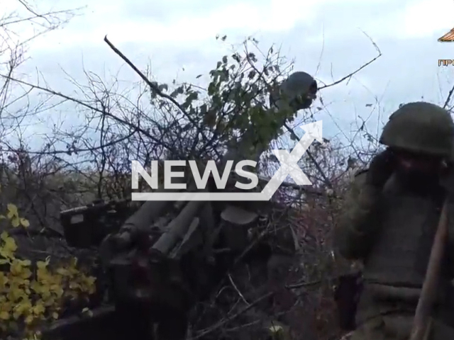 DPR soldiers shoot a howitzer among trees in direction of Opytne and Vodyane settlements, Donetsk region, Ukraine in undated photo. Artillerymen of the 1st Slavic Brigade of the People's Militia of the DPR destroyed two strongholds of Ukrainian army. Note: Picture is a screenshot from a video (@nm_dnr/Newsflash)