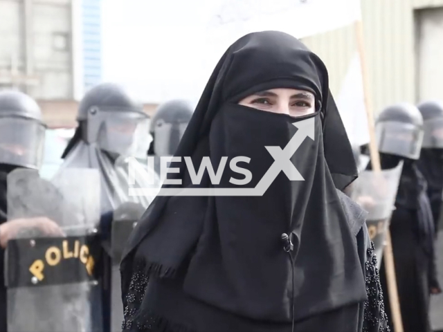 An Afghan female officer poses in an undated photo. The Ministry of Interior Affairs of Afghanistan shared a video of police training, showing female officers wearing head-to-toe black veils, up in an open group, flashing anti-riot gear and a Taliban flag on Monday, Oct. 31, 2022. Note: Picture is a screenshot from a video (@moiafghanistan/Newsflash)