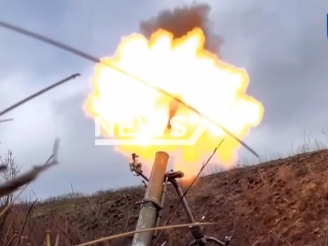 Mortar shoots in a field area in Ukraine in undated photo. Fighters of the Izyum Separate Territorial Defense Battalion fixed captured Russian 120 mm mortar and used it in combat work. Note: Picture is screenshot from a video (@troskhidzsu/Newsflash)