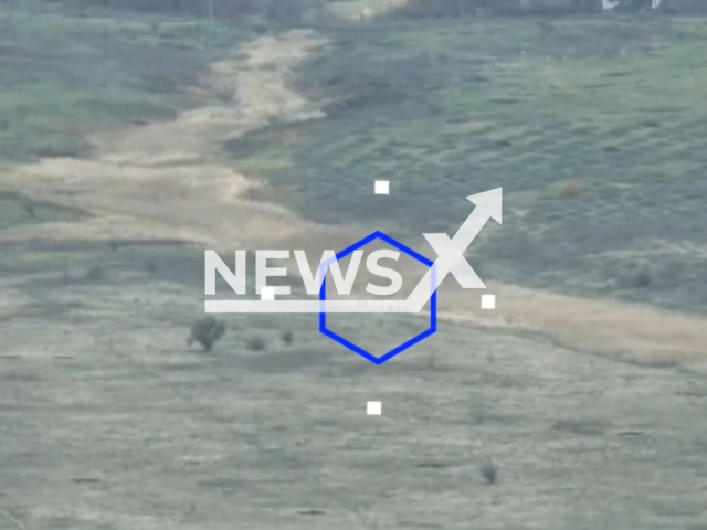 Group of Ukrainian soldiers move down the road in a field area in Vodyane settlement, Donetsk region, Ukraine in undated photo. Scouts of the special forces battalion of the People's Militia of the DPR revealed Ukrainian stronghold and hit it with mortar fire. Note: This picture is a screenshot from the video. (@nm_dnr/Newsflash)