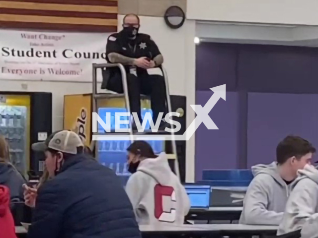 Description: Ashlyn Long,17, films how a cop sits in a lifeguard tower to watch for lunchroom fight in Ballston Spa, New York, United States. Notes: Photo is a screenshot from the video(@ashlynlonggg/Newsflash)