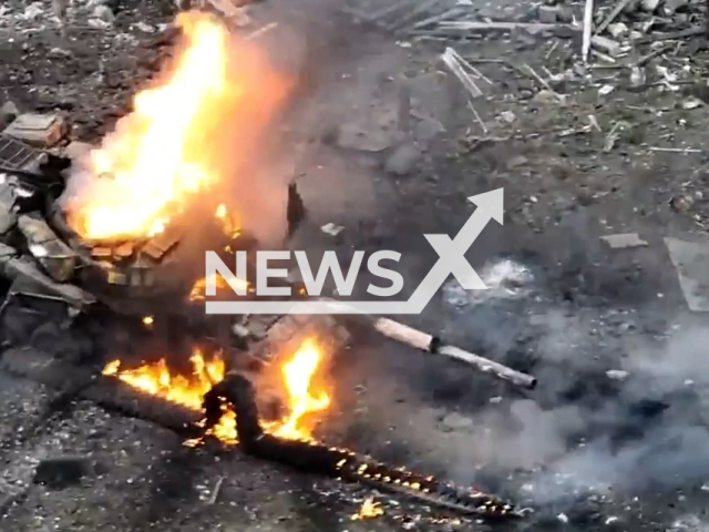 Russian tank burns in Donetsk region of Ukraine in undated photo. Fighters of the division of the 79th separate amphibious assault brigade of Mykolaiv destroyed Russian tank supporting Russian infantry with fire during Russian storming the positions of Ukrainian brigade. Note: Picture is screenshot from a video. (@79AMBUA/Newsflash)