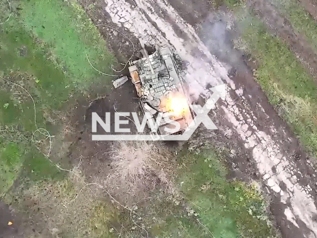 Russian tank explodes in a field area in Ukraine in undated photo. Drone operators of the 79th separate amphibious assault brigade of Mykolaiv destroyed Russian servicemen and disabled Russian military equipment. Note: Picture is a screenshot from a video (@79AMBUA/Newsflash)