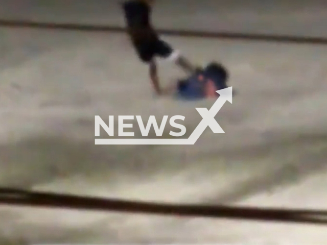 A  husband kicks his wife on the beach in Guaruja, Brazil, on Sunday, Nov. 6, 2022. A group of men attacked the man   and a woman helped move her away from the aggressor, police are investigating. Note: Picture is a screenshot from a video (Newsflash)