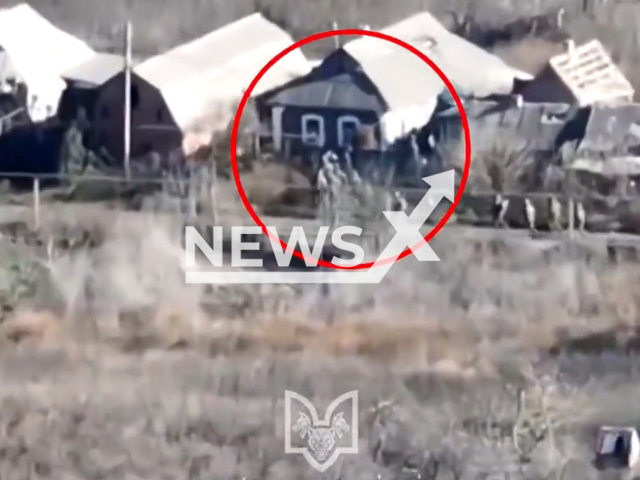 Russian soldiers move in a residential area of Pavlivka settlement, Donetsk region, Ukraine in undated photo. Fighters of the Wolves Da Vinci special unit of the Armed Forces of Ukraine shot at positions of Russian army. Note: Picture is a screenshot from a video (@VovkyDaVinchi/Newsflash)