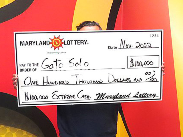 An entrepreneur, 54,  known as 'Gato Solo' poses with his USD 100,000 Extreme Cash scratch-off win check, undated. Earlier this year he won USD 30,000 on another scratch-off. Note: Licensed photo.  (Maryland Lottery/Newsflash)