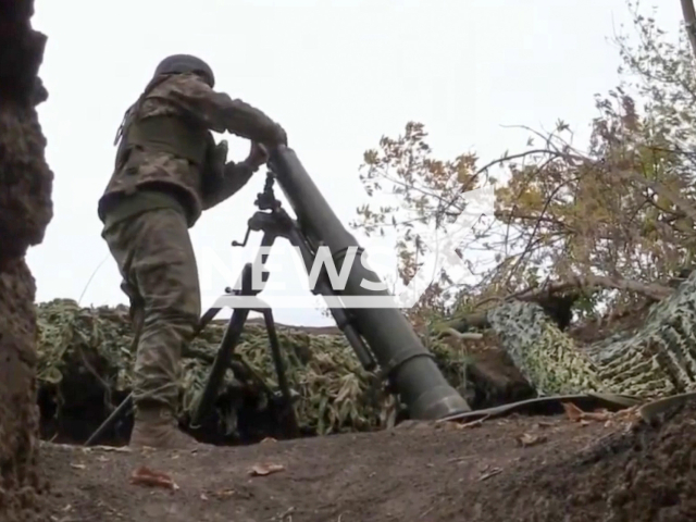 This footage shows a Ukrainian soldier using 120-millimetre mortars in Donets Region, Ukraine in undated video. Note: This picture is a screenshot from this video. (State Border Service of Ukraine/Newsflash)