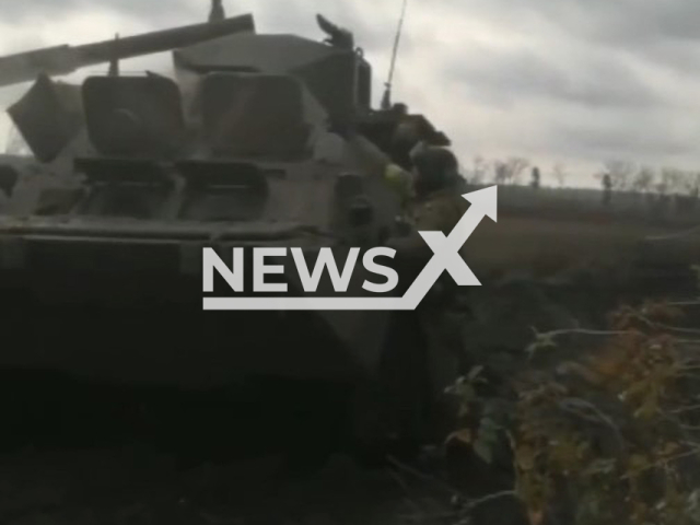 Ukrainian fighter throws a grenade into the open hatch of Russian tank in the Luhansk region, Ukraine in undated photo. Soldiers of the 25th Separate Airborne Sicheslav Brigade captured a command car and two tanks of the Russian invaders. Note: Picture is screenshot from a video (@dshv25opdbr/Newsflash).