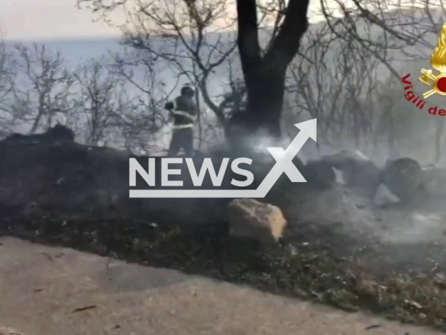 Italian firefighters extinguishe a woodfire in Busachi, Sardinia, Italy. Note: The picture is a screenshot from a video (@vigilidelfuoco/Newsflash)