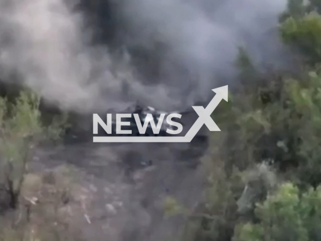 Picture shows Russian tank in a gun smoke among trees in the Donetsk direction of Ukraine in undated photo. Border aerial reconnaissance detected Russian enemy positions and corrected fire from artillery, as result Russian tank and ammunition was destroyed. Note: Picture is a screenshot from a video (@dpsu.gov.ua/Newsflash)