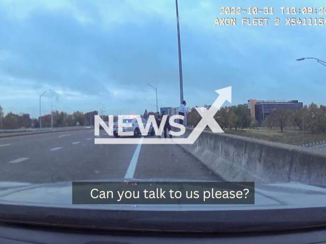 Police officers rescue a woman standing on the ledge of an overpass in Louisville, Kentucky, USA in undated video.Note: Picture is screenshot from a video. (Louisville Metro Police Department/Newsflash)