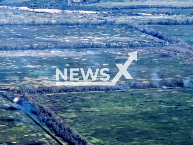 Picture shows explosions and tank near treeline in a field area in the settlement of Nevelske, Donetsk region, Ukraine in undated photo. Tankers of the 100th guards brigade of the People's Militia of the DPR attacked Ukrainian stronghold under the cover of an infantry fighting vehicle. Note: Picture is a screenshot from a video (@nm_dnr/Newsflash)