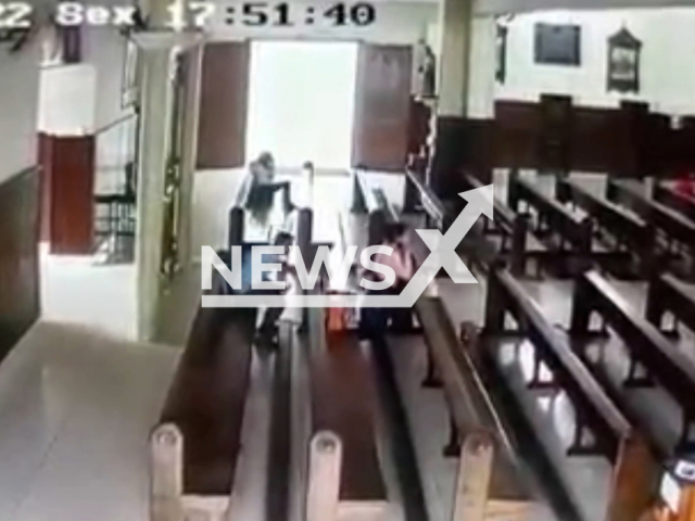 A thief steals the bag from a woman praying at a church in Lavras , Brazil, on Friday, Nov. 4, 2022. Police arrested the suspect, the bag and some belongings that were in it were found. Note: Picture is screenshot from a video (Newsflash).