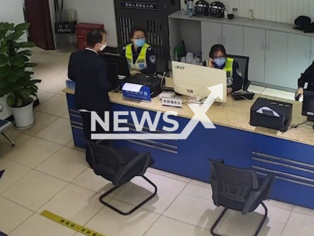 Man enters police station to apply for certificate of no criminal record and the police finds out that he is a wanted fugitive in Shapingba District, Chongqing in China, undated. He was then arrested. Note: Picture is screenshot from a video (spb_110/AsiaWire).