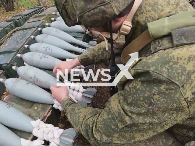 DPR soldier chooses rocket for mortar in Zaporizhzhia region, Ukraine in undated photo. Soldiers of the People's Militia of the DPR detected accumulation of Ukrainian manpower and DPR mortar crew shot at Ukrainian troops. Note: Photo is a screenshot from the video (@nm_dnr/Newsflash)