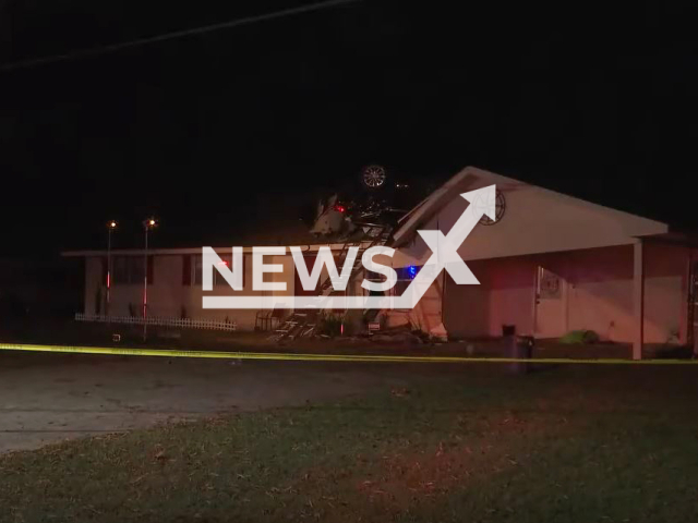 Picture shows a car on the roof of a house in Zachary, Louisiana, USA,  on  Friday, Nov. 11, 2022. A woman was rescued and taken to hospital, she likely suffered a medical emergency before the crash.
Note: Photo is a screenshot from a video. (Newsflash)