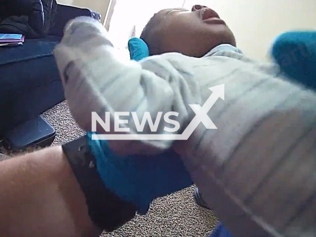 A police officer rescues an infant that wasn't breathing in Kansas City, Missouri, USA, undated. Police officer visited the baby in the hospital after the incident. Note: Picture is screenshot from a video (KansasCityPolice/Newsflash)