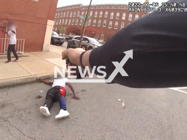 Police officer pointing at the suspect with the gun after he shot him in Baltimore, Maryland, USA on Sunday, Nov. 6, 2022.Note: The picture is screenshot from a video (Baltimore Police/Newsflash).