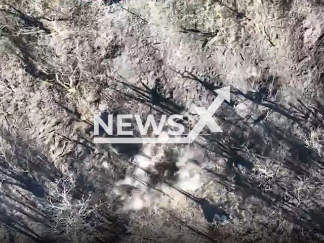 Picture shows an explosion near Russian soldier laying on the ground in a field area of Ukraine in undated photo. Ukrainian fighters of the drone unit "OCHI" of the Ukrainian Ground Forces detected Russian invaders and dropped bombs on them. Note: Picture is a screenshot from a video (@landforcesofukraine/Newsflash)