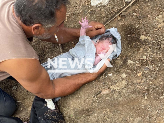 A man holds a newborn baby girl that was found inside a backpack thrown into the Capibaribe River, in Sao Lourenco da Mata, Brazil, on Thursday, Nov. 17, 2022. A man on a motorcycle threw the baby from a bridge, witnesses found the crying baby and rescued it.
Note: Private photo.  (Newsflash)