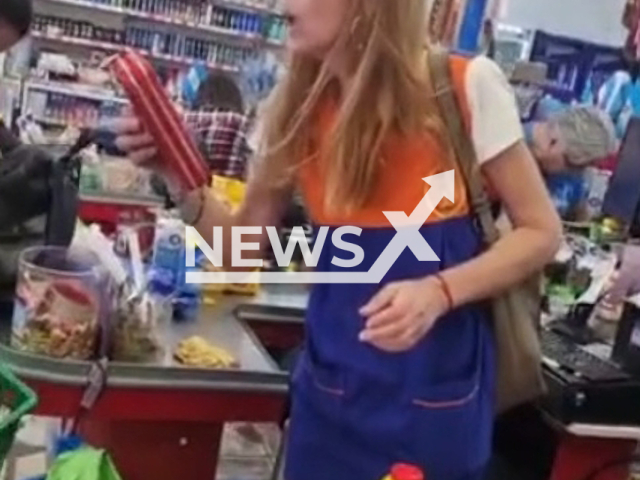 A teacher caught stealing at a supermarket arrges with employee at checkout, in Puerto Iguazu, Argentina, on Tuesday, Nov. 15, 2022. Employees  confronted her and she  took  out a several  products from inside her bag as she apologized. Note: Picture is a screenshot from a video (Newsflash)