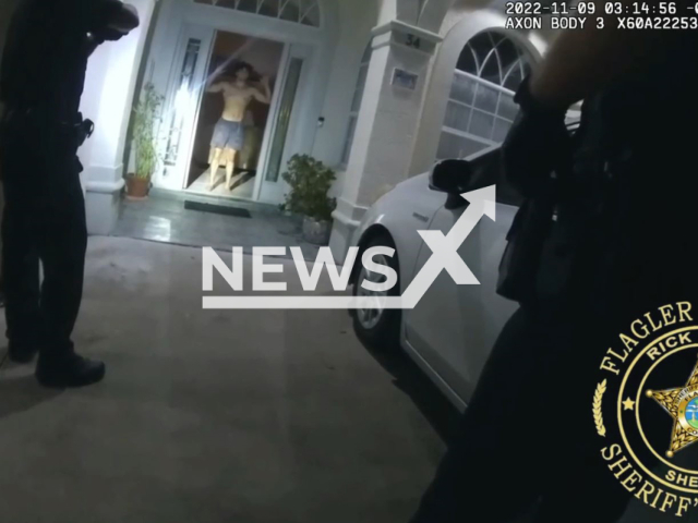 Police officer arresting the suspect Luke Ingram, 19 for brutally murdering a family member and assaulting another in Flagler County, Florida, USA on Wednesday, Nov. 9, 2022. Ingram was placed behind bars and is currently being held on no bond. Note:Picture is screenshot from a video (Flagler County Sheriff's Office/Newsflash)