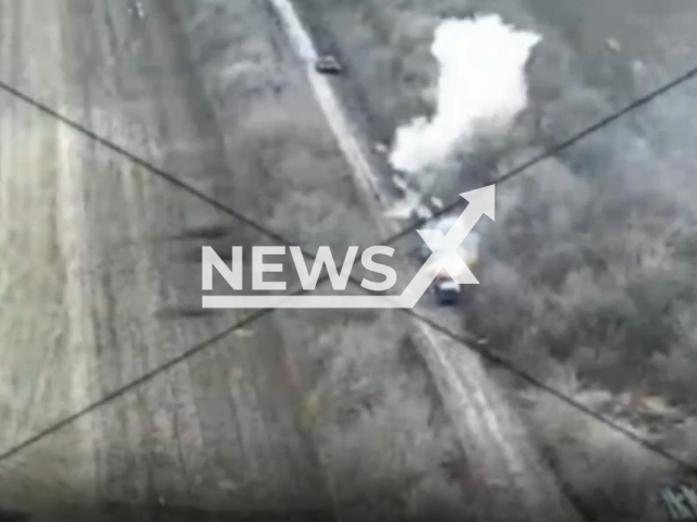 Russian military equipment explodes on a road near trees in Ukraine in undated photo. Fighters of the 40th Separate Artillery Brigade named after Grand Duke Vytautas with their colleagues from the 53rd Separate Mechanized Brigade named after Volodymyr Monomakh destroyed Russian military equipment and stronghold. Note: Picture is screenshot from a video (@40OAbrigade/Newsflash).