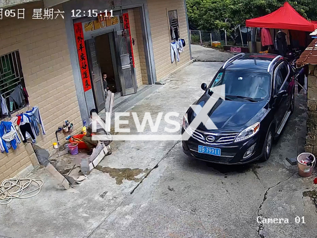 Tiles fall on man's back in Lufeng, China, Saturday, Nov. 5, 2022. His injuries were reportedly not serious. Note: Picture is screenshot from a video (1455300122/AsiaWire).