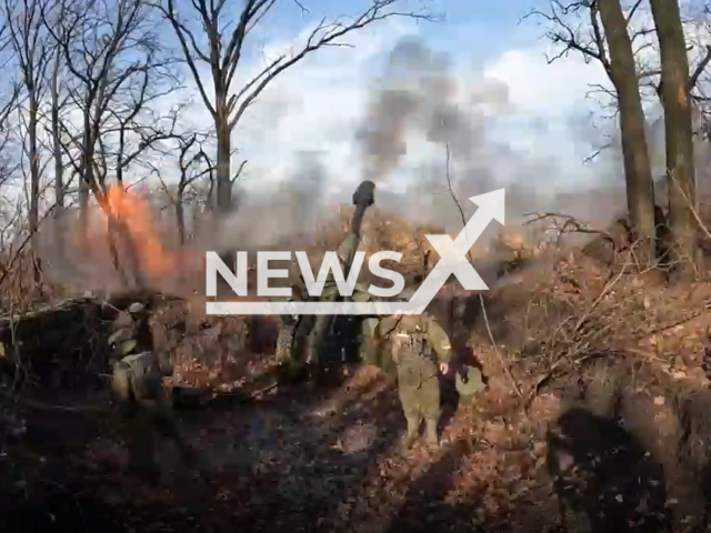 DPR soldiers shoot a howitzer among trees in direction of Vodyane, Zaporizhzhia region, Ukraine in undated photo. Artillerymen of the 1st Slavic brigade of the People's Militia of the DPR hit fortified areas of Ukrainian army with help of 152 mm D-20 gun-howitzer. Note: Photo is a screenshot from a video(@nm_dnr/Newsflash).