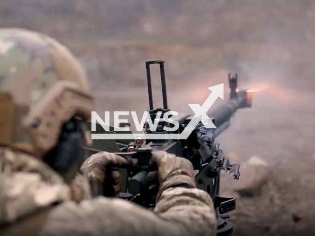 Ukrainian soldier shoots machine gun during combat training in Ukraine in undated photo. Fighters of the 104th brigade of the Territorial Defense of the Rivne region of Ukraine improve their knowledge and skills in using large-caliber machine guns. Note: Photo is a screenshot from a video(@104TRORivne/Newsflash).