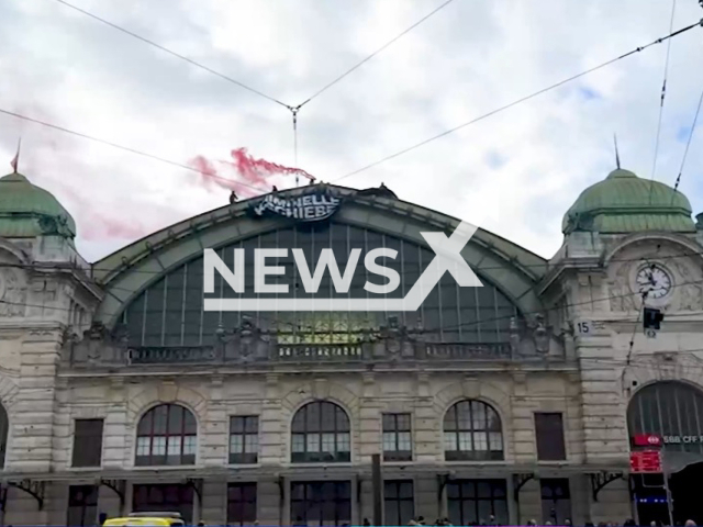 Image shows the far-right extremists at the Basel train station in Switzerland, undated photo. They were arrested after they set off firecrackers and unfurled a banner saying 'Deport criminals' on Sunday, Nov. 20, 2022. Note: Photo is a screenshot from a video. (Newsflash)