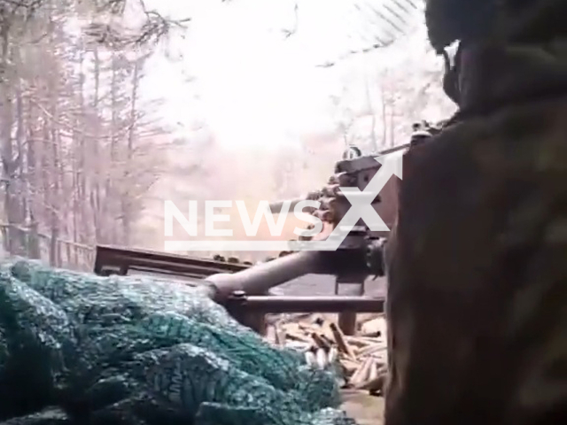 Ukrainian soldier shoots machine gun from his camouflaged dugout with his colleagues and in Ukraine. The footage was obtained from the Armed Forces of Ukraine on Wednesday, Nov. 23, 2022. Note: Picture is a screenshot from a video (@AFUkraine/Newsflash)