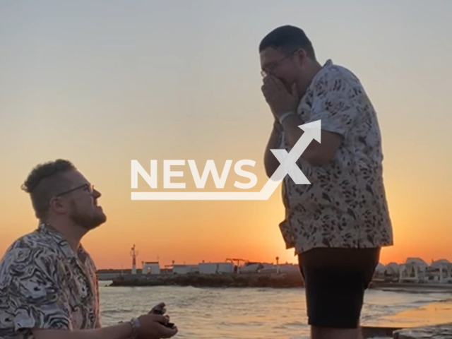 Bradley Fox-Jones, 25, proposes to Joshua Barker, 23, in Gouves, Crete, on Thursday, July 21, 2022. According to Bradley, the two met at a gay nightclub in Portsmouth, on Nov. 10, 2017. Note: Picture is a screenshot from a video (@bradleyfoxjones/Newsflash)