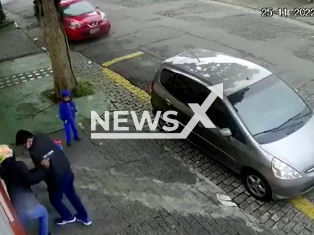 A father is robbed at gun point with his son as he is taking him to school, in Sao Paulo, Brazil, on Friday, Nov. 25, 2022. The father and robber struggle, as he does not want to give him his belongings, before the robber flees. 
Note: This picture is a screenshot from the video.
(Newsflash)