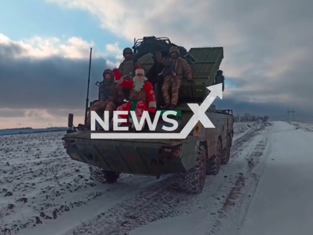 Ukrainian soldiers and a man in the costume of Santa Claus wave hands sitting on 9K33 Osa surface-to-air missile system in a snowy field in Ukraine. The footage was obtained from the AFU StratCom on Monday, Nov. 28, 2022. Note: Picture is a screenshot from a video (@AFUStratCom/Newsflash)