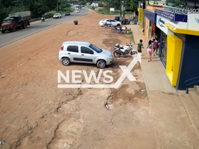 A truck tire comes off, crosses the road  Santarem, Brazil, on Saturday, Nov. 26, 2022.  The tire hit  a motorcycle and a  43-year-old woman identified as Ana Claudia Menezes, she convulsed at the scene of the accident, her condition is considered delicate. Note: Picture is screenshot from a video (Newsflash).