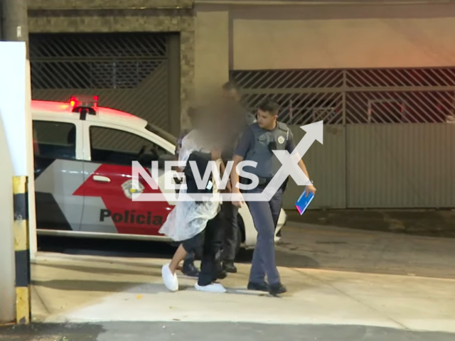 Police officers walk with an English man, ( with the blur) who had been kidnapped and rescued, in Sao Paulo, Brazil,  on Tuesday Nov. 29, 2022. Police received an anonymous report, the police located the three suspects described by the complainant and arrested them, they told police where the victim was. 
 
Note: Photo is a screenshot from a video. (Newsflash)