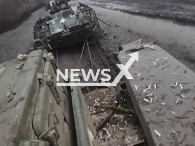 Description: Ukrainian fighters of National Guard pull their tanks on a rope along a muddy road in Ukraine. The footage was obtained from the National Guard of Ukraine on Wednesday, Nov. 30, 2022. Notes: Picture is a screen from a video(@NGUmainpage/Newsflash)