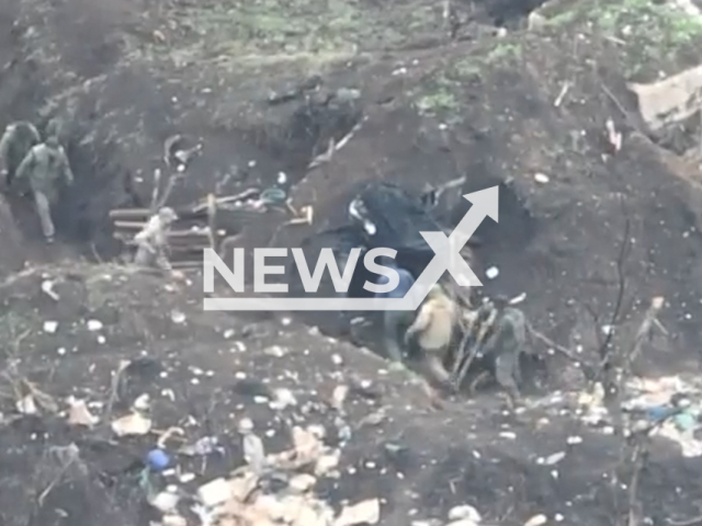 Russian soldiers go inside their dugout in Bakhmut, Donetsk region, Ukraine. The footage was obtained from the 30th separate mechanized brigade of the Ukrainian Ground Forces on Thursday, Dec. 01, 2022. Note: Picture is screenshot from a video (@30brigade/Newsflash).