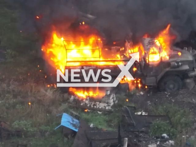 Russian military truck burns in a residential area of Ukraine. The footage was obtained from K2 combat group of the 54th brigade of the Ukrainian Ground Forces on Saturday, Dec. 03, 2022. Note: Picture is a screenshot from a video (@k_2_54/Newsflash)