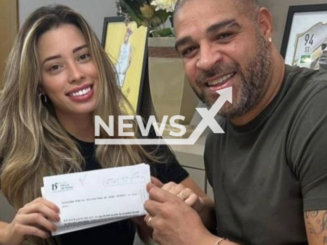 Adriano Imperador and his wife Micaela Mesquita pose with marriage contract in undated photo. After 24 days   of marriage, the couple allegedly separated because he  had gone to watch the match between Brazil and Switzerland,in Rio de janeiro Brazil, and returned home two days later. 
Note: Private photo.  (Newsflash)