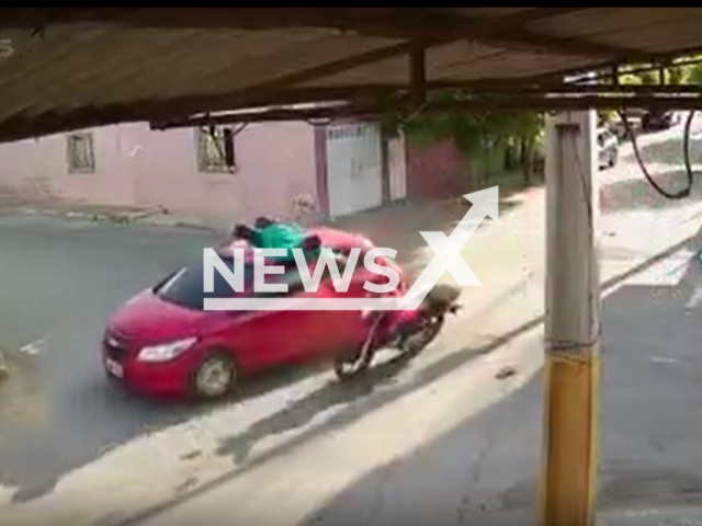 A motorcyclist that hit  a car, spins on the vehicle  in Forquilha, Brazil, on Sunday, Nov. 27, 2022. The man was not injured and walked away after.  Note: Picture is screenshot from a video (Newsflash).