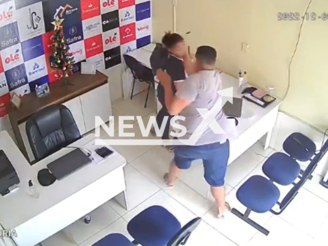 A man punches his ex partner, at  her workplace in Santa Helena, Brazil, on Friday, Dec. 2, 2022. He stabbed her and then cut  his own neck, after she refused to take him back, they were both taken to the hospital, where he was arrested.   Note: Picture is a screenshot from a video (Newsflash)