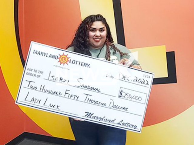 Isabel Sandoval, 35, poses  with a  USD 250,000 prize check from the Lady Luck scratch-off. She made a trip to the store to buy beer for her husband when she bought the scratch-off in Baltimore, Maryland, USA, in November, 2022. Note: Licensed photo.  (Maryland Lottery/Newsflash)