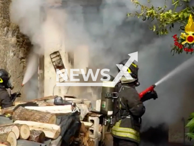 Firefighters from the Avellino Fire Brigade extinguish a fire in a house in the town of Forino, Italy on Friday, Nov. 25, 2022. The elderly couple that lived in the house managed to save themselves in time. Note: Picture is screenshot from a video (Vigili del Fuoco/Newsflash).