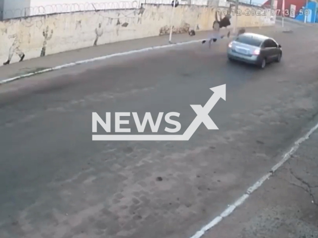 Two people on a motorcycle fly into the air after being hit by car in Acopiara, Brazil, on Saturday, Dec. 10, 2022. The vehicle drove into  the opposite laneand the two people impacted survived with injuries and are hospitalized. Note: Picture is a screenshot from a video (Newsflash)