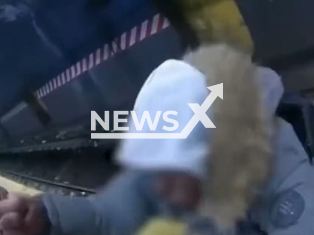 NYPD officers rescue an intoxicated man who fell onto subway tracks before he could get run over by an oncoming train in Brooklyn, New York, USA, undated. Police later reportedly discovered that the man was transported to a local hospital for treatment and evaluation. Note: This picture is a screenshot from the video. (@NYPDPC/Newsflash)